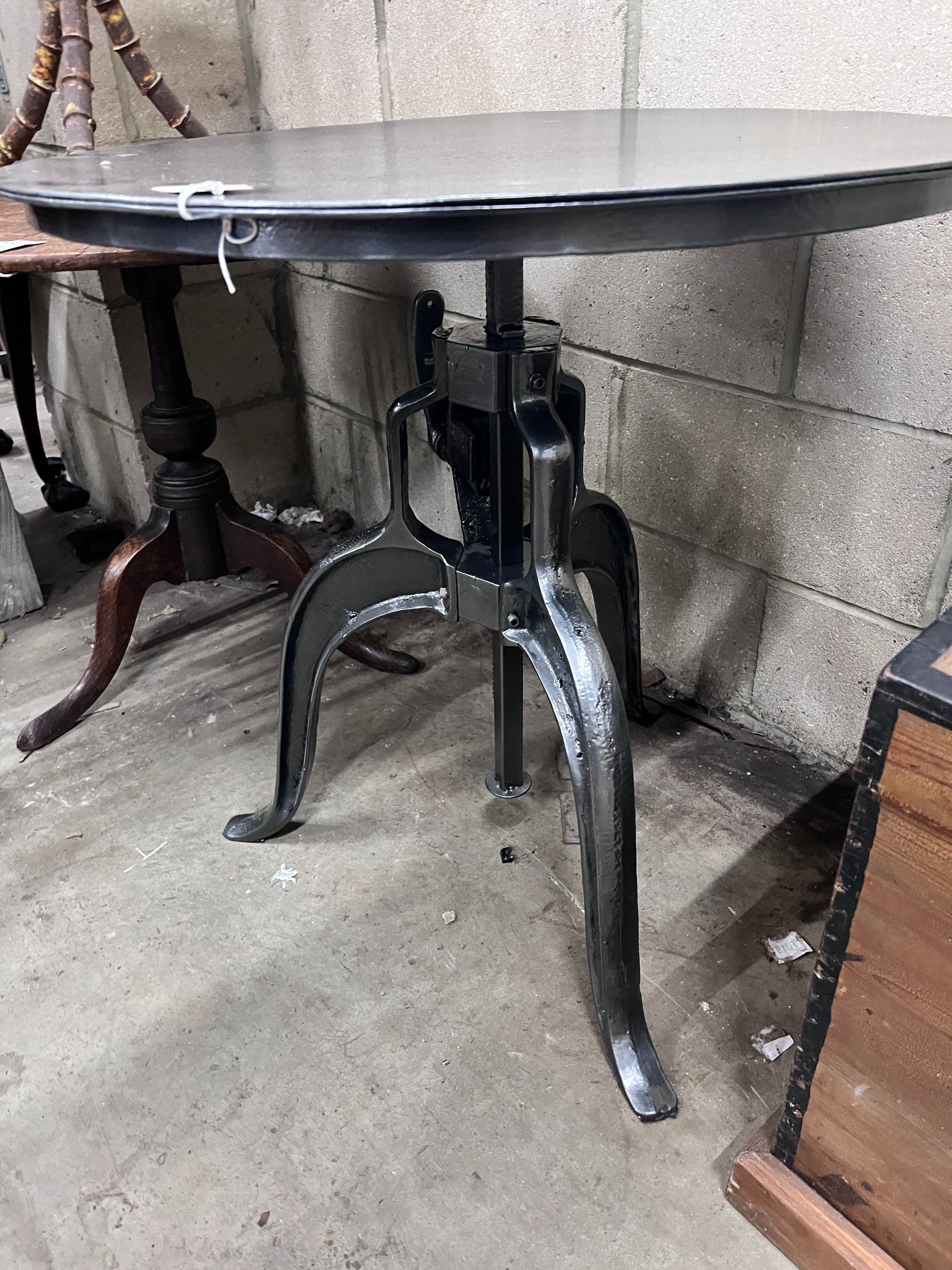 A cast iron and painted metal adjustable circular occasional table, width 75cm *Please note the sale commences at 9am.